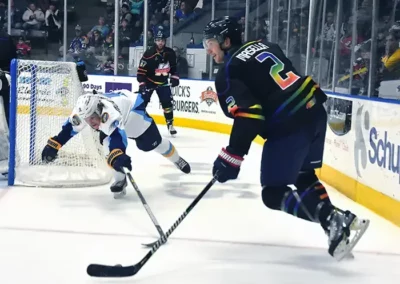 Image of Kwings Rainbow Ice Hockey player with puck