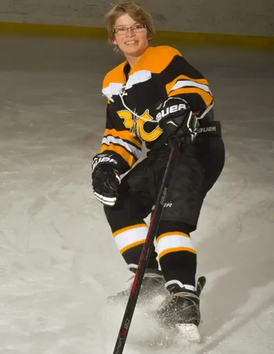 Image of Nelson stopping on ice and smiling for portrait