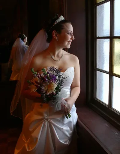 Image of Michelle at her wedding peering out window