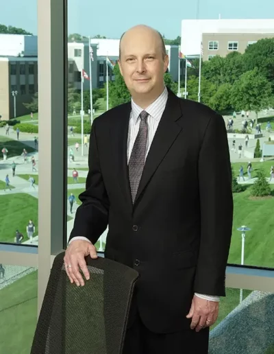 Image of Western Michigan Board of Trustee Rinevelt in Sangren overlooking courtyard